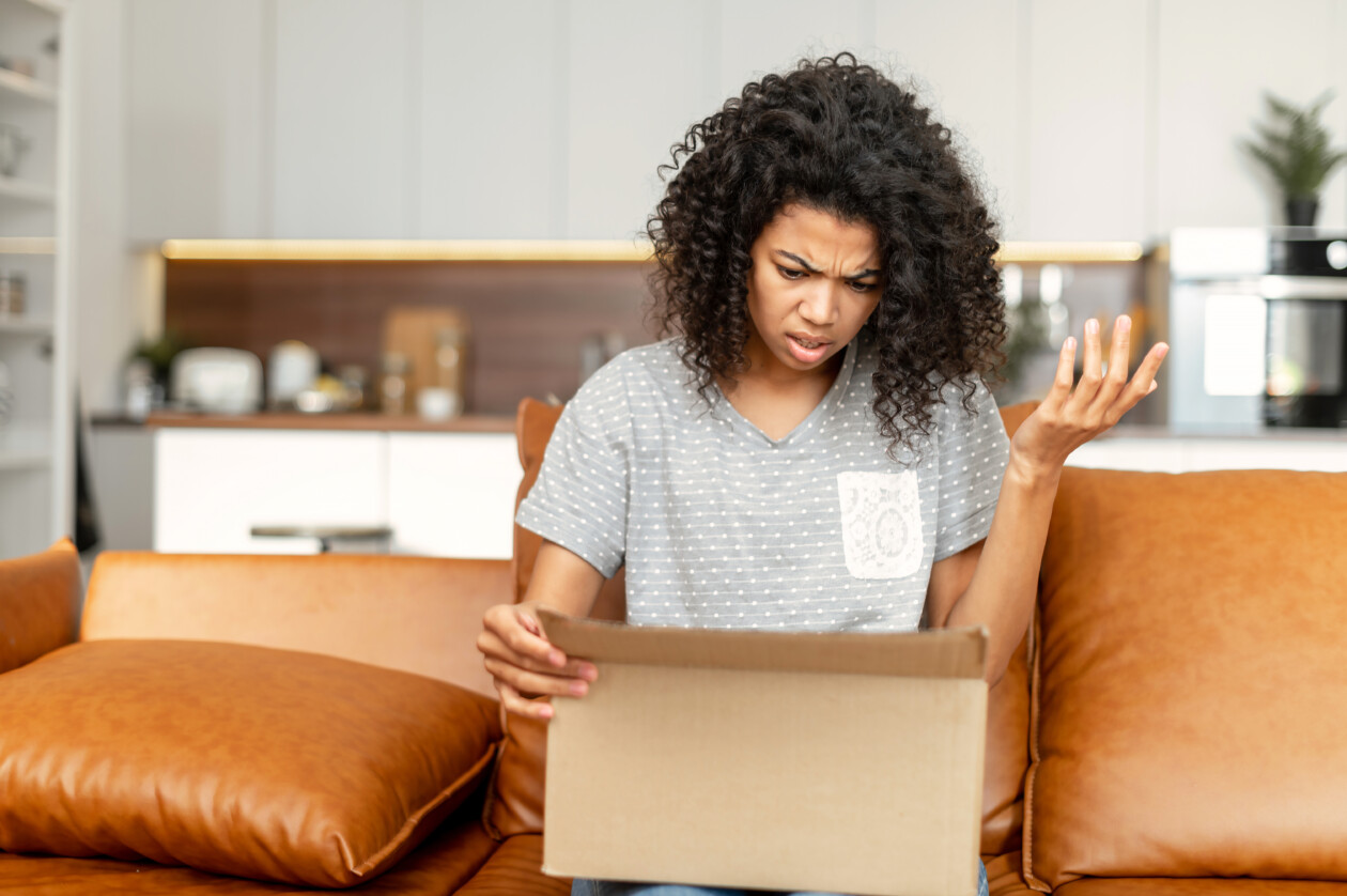 An african american woman unpacking a box