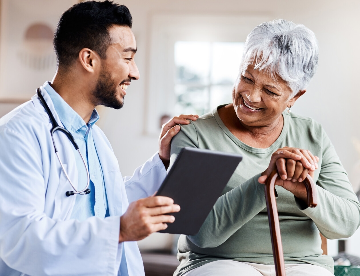 It was nothing to worry about. shot of a young doctor sharing information from his digital tablet with an older patient.